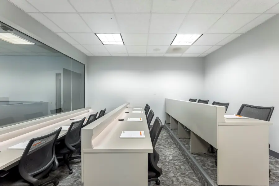 Discreet client viewing room at L&E Research Chicago, featuring an expansive one-way mirror for uninterrupted participant observation.