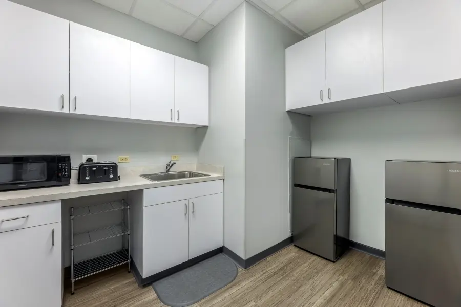 Adjacent utility support and medical prep space at L&E Research Chicago, equipped with lab counters and refrigeration for healthcare device testing.