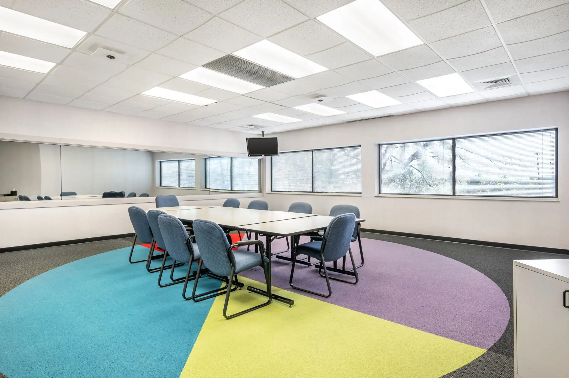 Spacious qualitative research room within the Mt. Adams focus group suite at L&E Research Cincinnati, featuring flexible modular tables.
