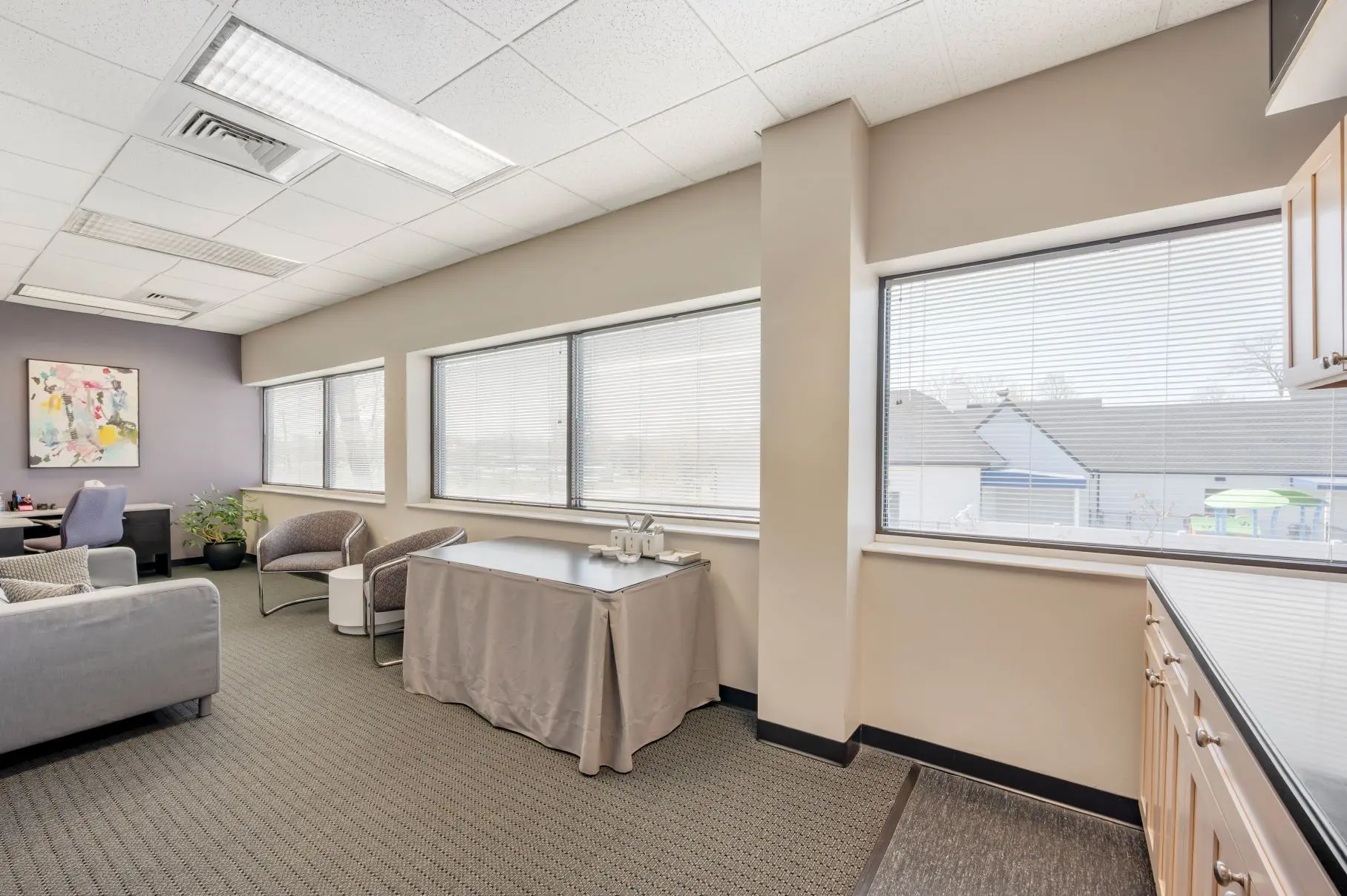 Executive client suite lounge in the Music Hall research hub at L&E Research Cincinnati, optimized for comfortable, secure remote observation.