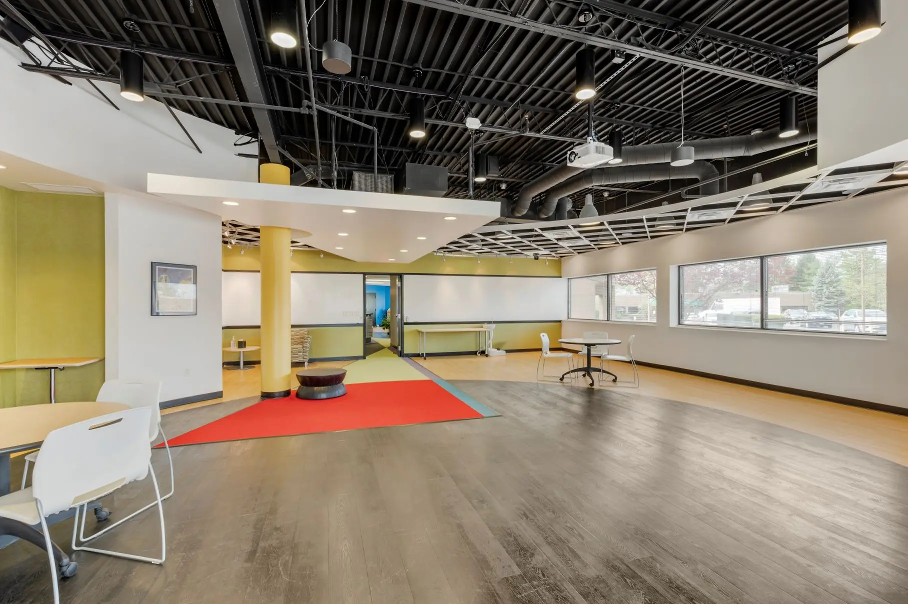 Spacious consumer co-creation room with expansive writeable surfaces and modular tables at L&E Research's Cincinnati facility.