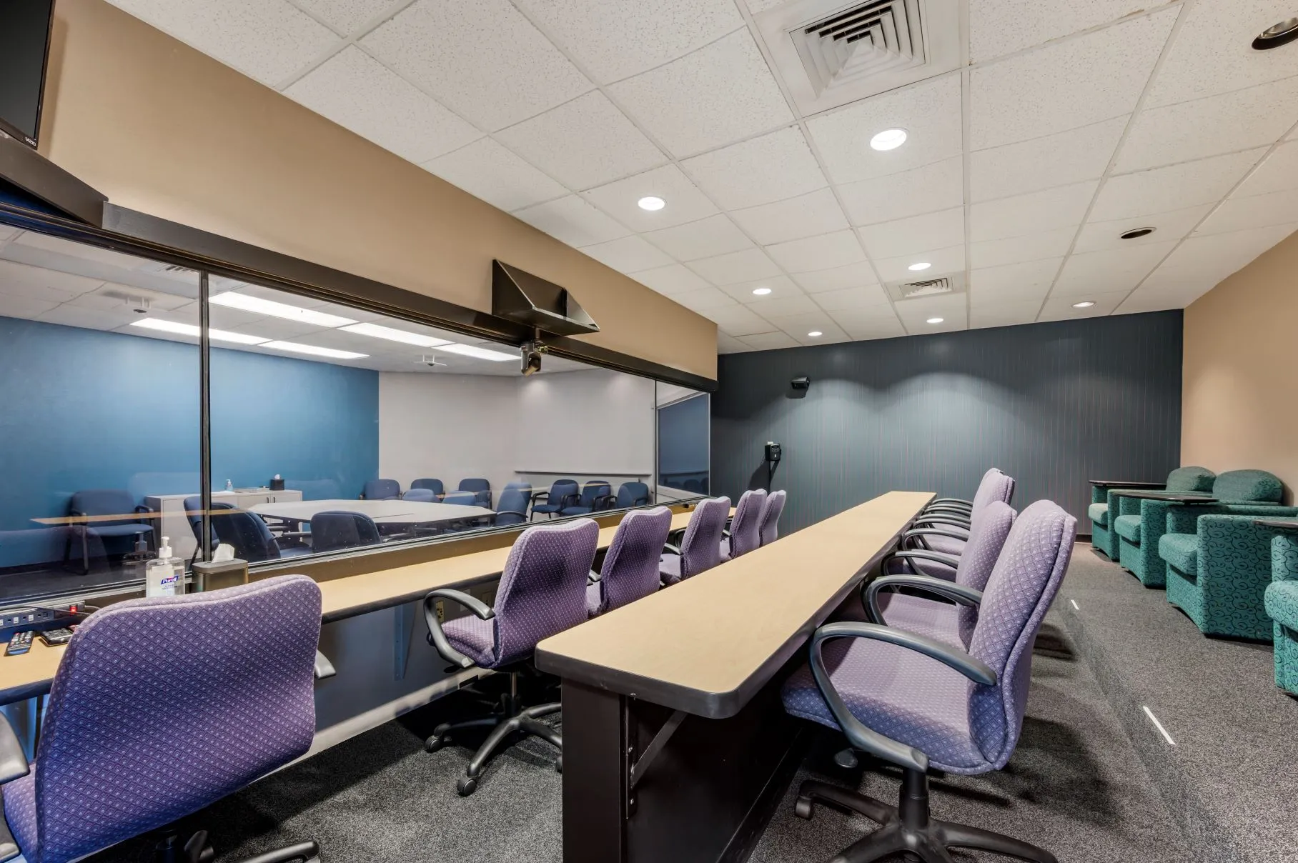Dedicated observer viewing room behind a one-way mirror in the Music Hall focus group suite at L&E Research Cincinnati.