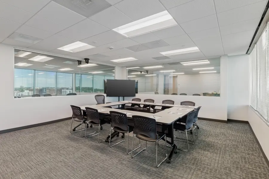 Spacious focus group room rental within the Mile High suite at L&E Research Denver, showcasing modular tables and scenic Rocky Mountain views.