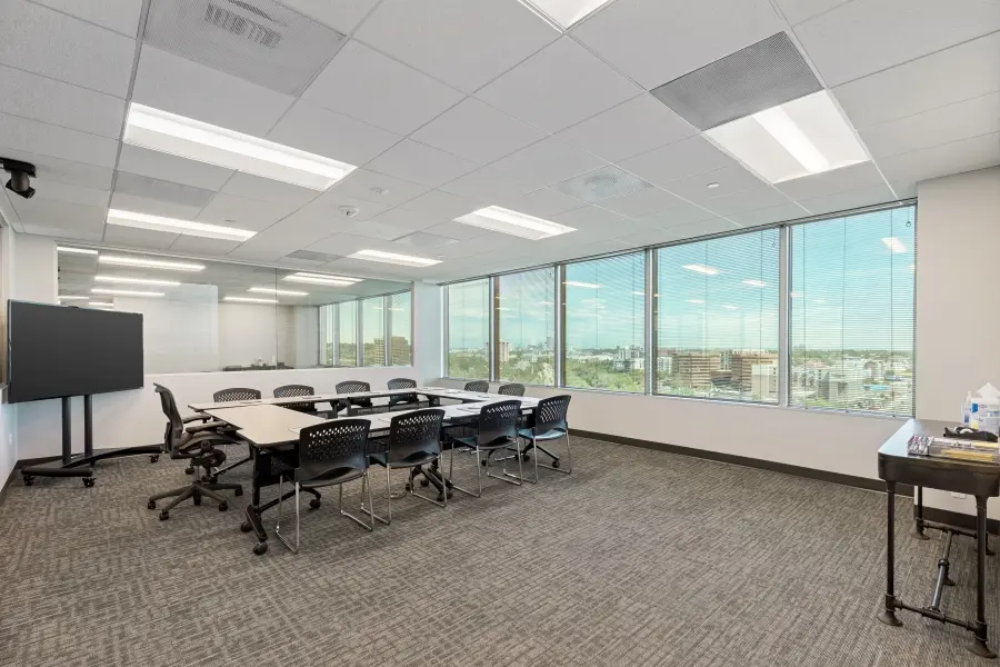 Large qualitative research room inside the Denver Mile High suite, arranged in a classroom layout for consumer insights and panel discussions.