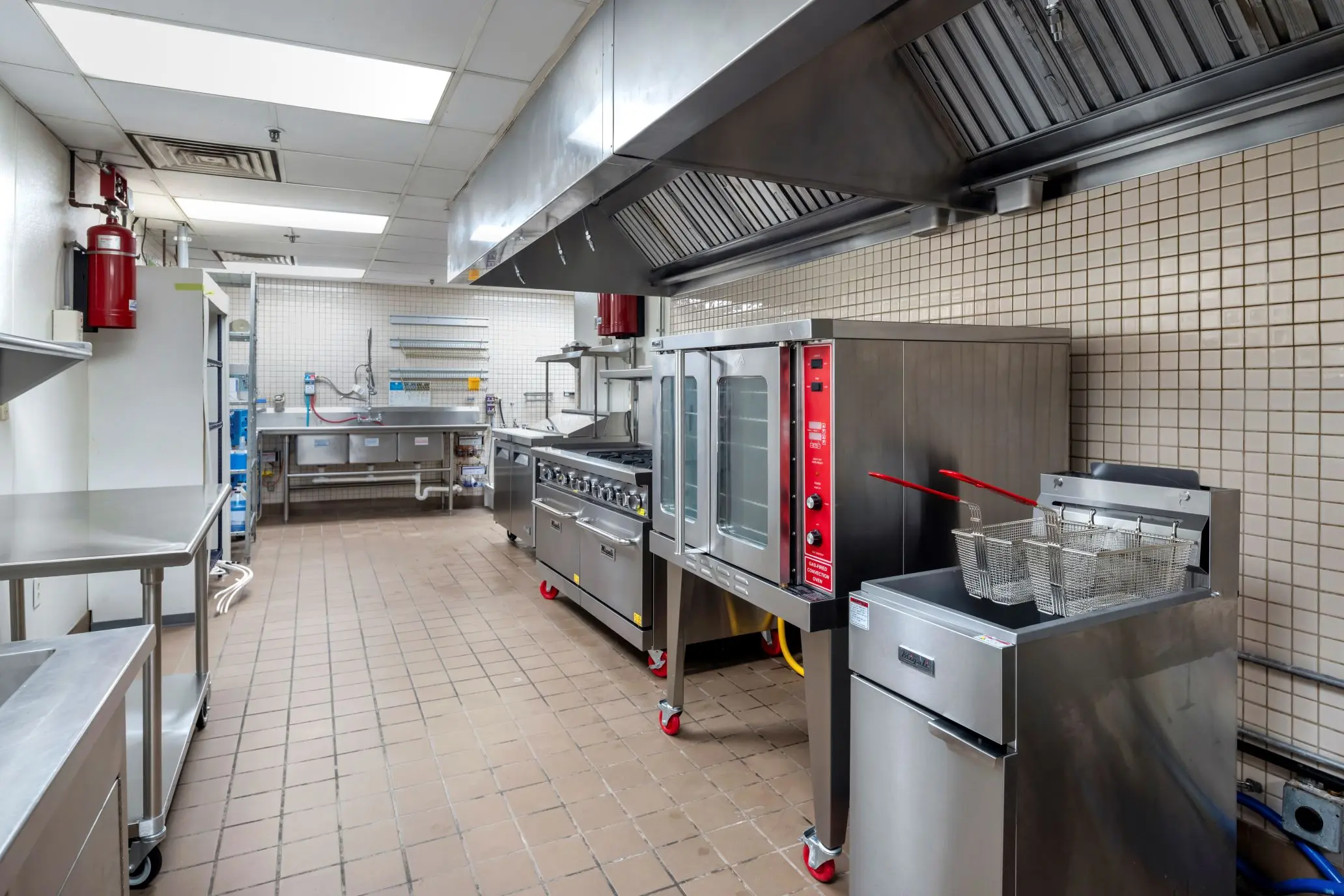 Detailed view of industrial heating and cooking line equipment inside the L&E Research sensory test kitchen in Columbus, Ohio.