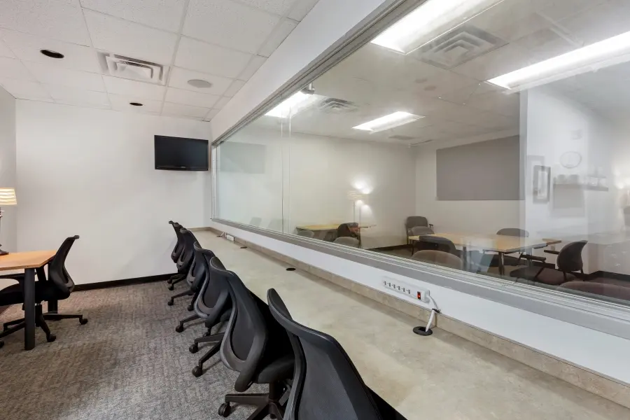 Comfortable stakeholder viewing lounge and workspace in the Pinehurst suite at L&E Research Raleigh, providing private desks for observers.