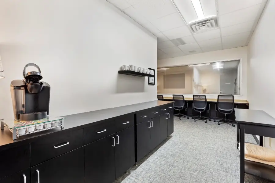 Combined client observation and premium viewing lounge in the Pinehurst suite at L&E Research Raleigh, featuring real-time digital streaming feeds.