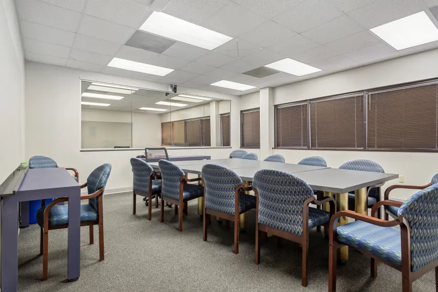 Versatile research room inside the Clearwater suite at L&E Research Tampa, set up for focus group discussions or consumer product handling.