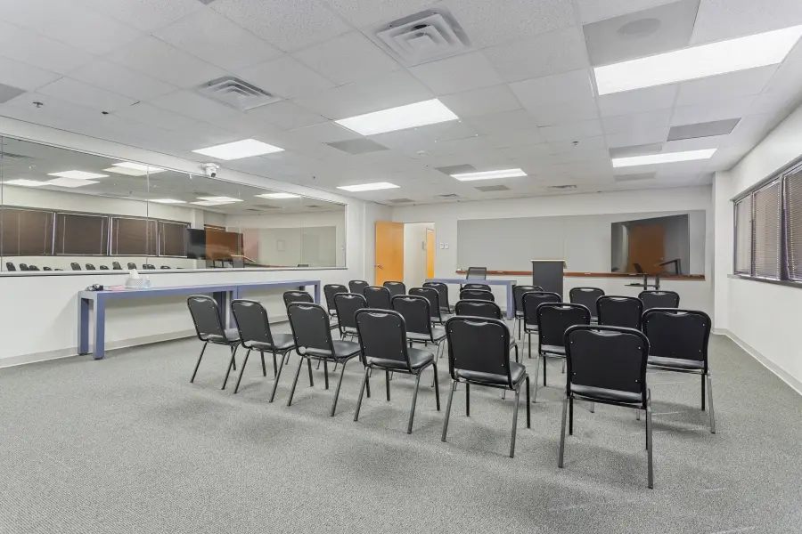 Large focus group room inside the Tampa Bay suite, arranged as a mock jury room layout for sample jury studies and litigation research.