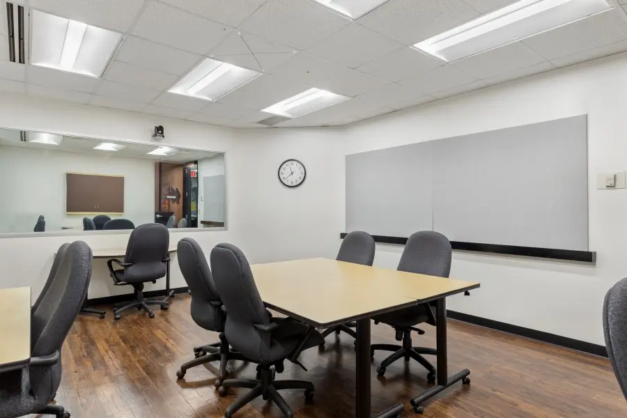 Flexible qualitative research space inside the Raleigh Hatteras suite, featuring modular tables for customized consumer testing.
