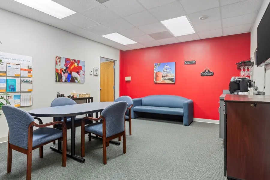 Premium corporate client lounge in the Tampa Bay suite at L&E Research, featuring private workspaces and secure HD streaming monitors.