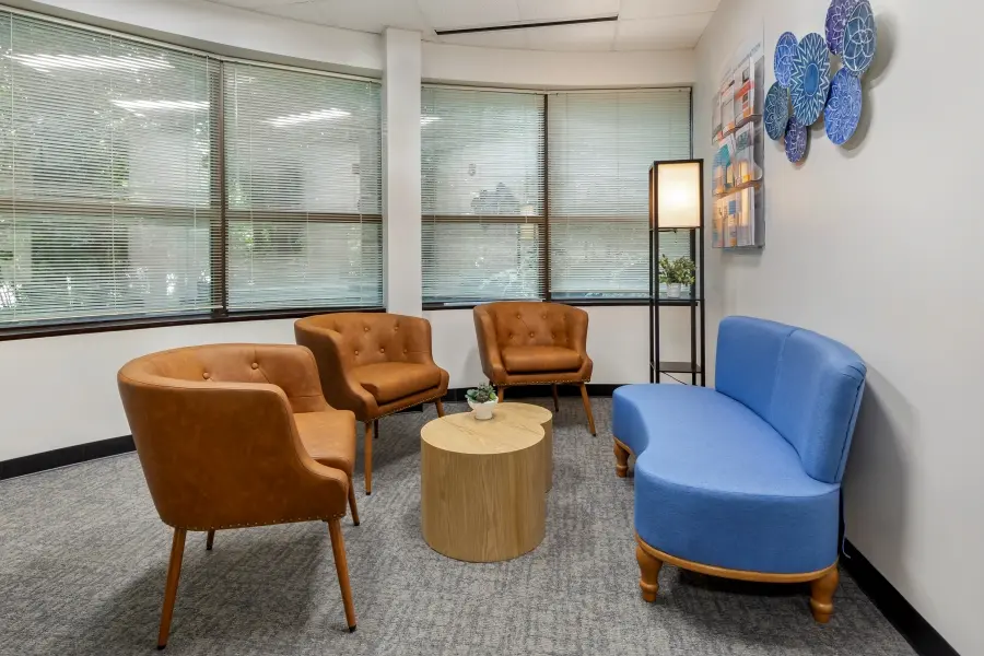 Stocked corporate client lounge in the Hatteras research suite at L&E Research Raleigh, providing private desks and live research streaming feeds.