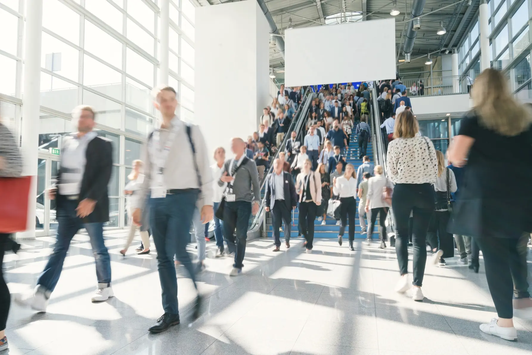 A crowd of people walking inside a building