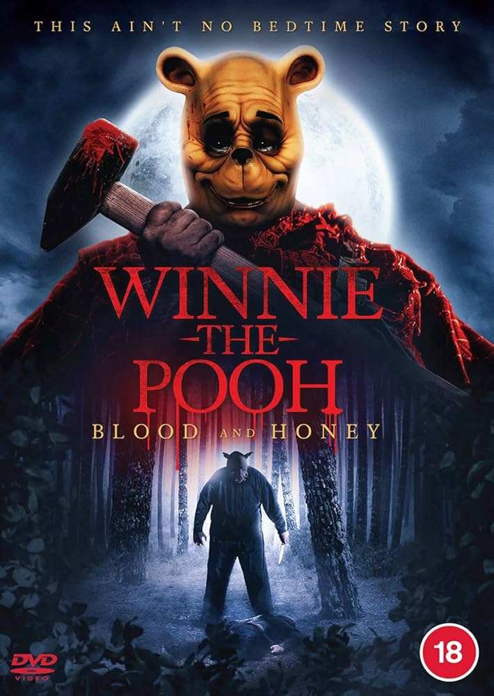 Creepy figure wearing a Winnie the Pooh mask holding a bloody hammer against a full moon in a dark forest.