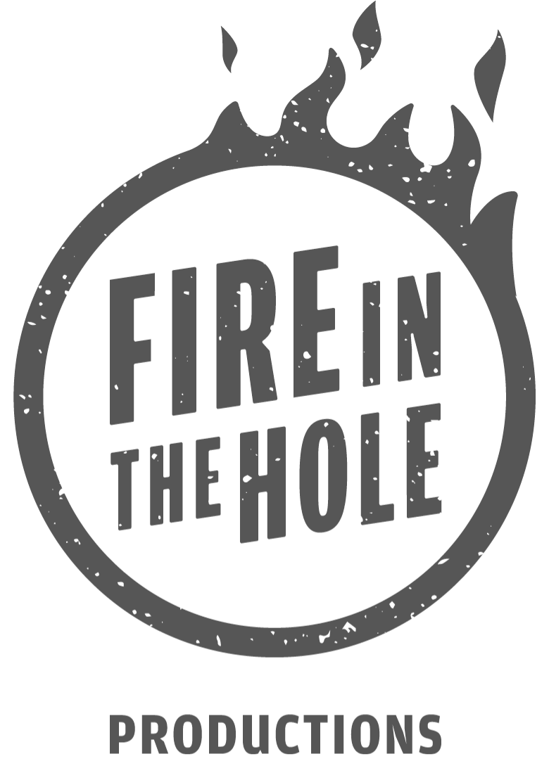 Logo with text 'Fire in the Hole' inside a circle with flames and 'Productions' below.