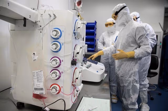scientists in PPE at our Memphis cell therapy CDMO center of excellence working in a cleanroom