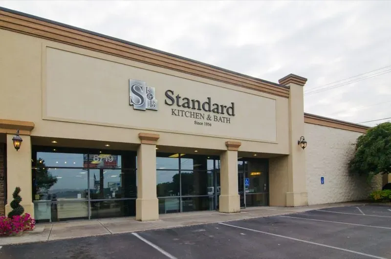 Exterior view of Standard Kitchen & Bath store with large windows and parking spaces in front.