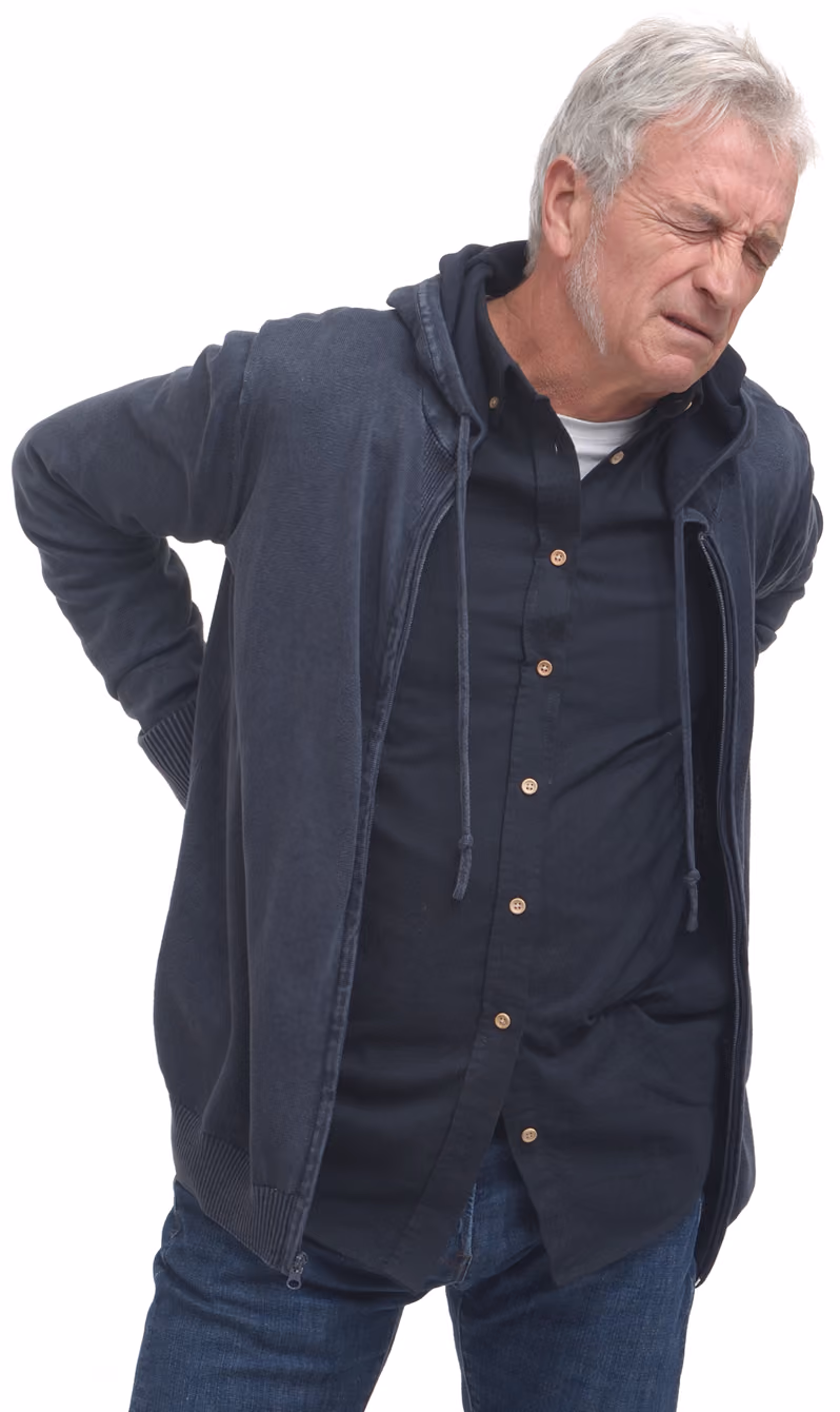 Older man grimacing in pain, holding his lower back while wearing a dark shirt and jacket.