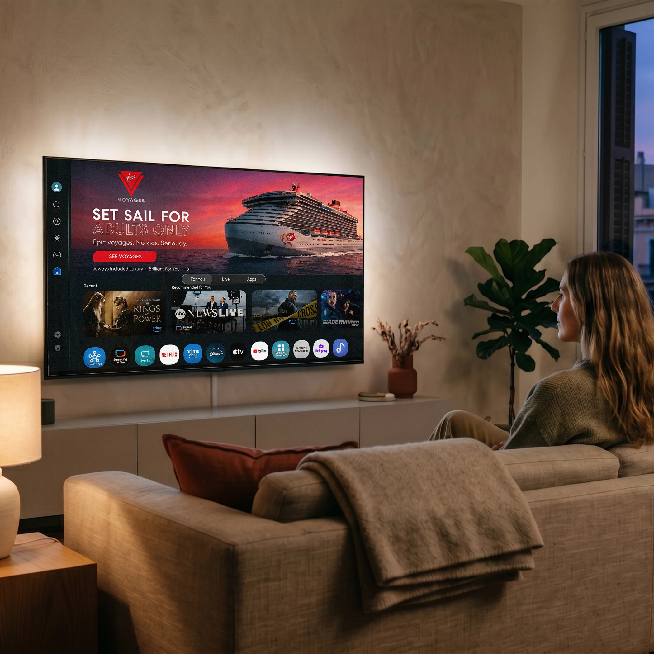 Woman watching a TV screen displaying a cruise shopping experience on Klyq in a cozy living room.