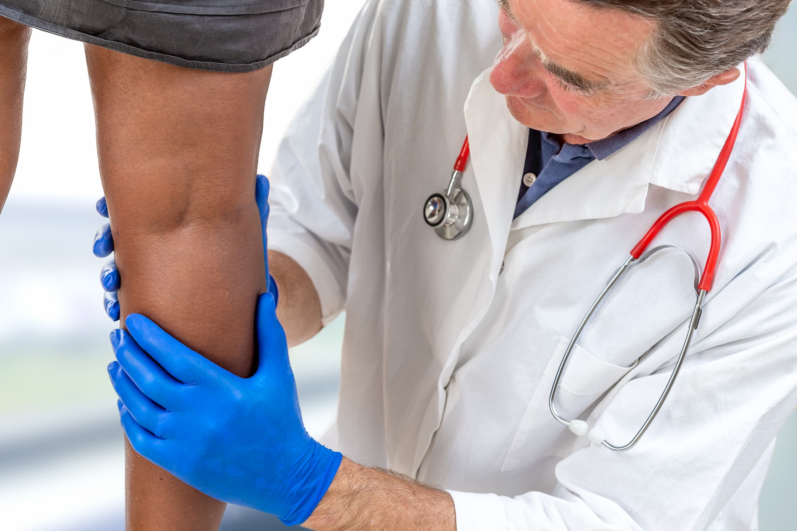 doctor looking at leg
