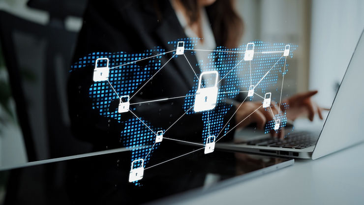 Person typing on a laptop, overlaid with digital padlocks connecting a world map. Image conveys cybersecurity. Blue and white tones dominate.
