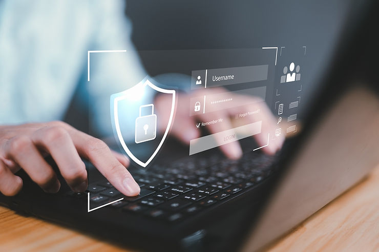 Hands typing on a laptop with a digital overlay showing login fields and a lock icon, suggesting cybersecurity. Dark, focused setting.
