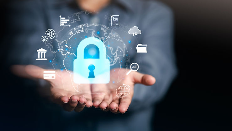 Hands holding a glowing padlock surrounded by digital security icons on a dark background, symbolizing data protection and technology.