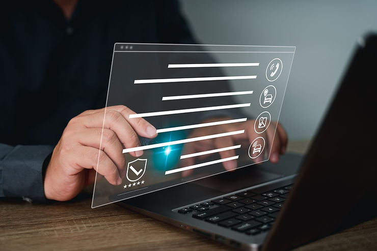 Hands interact with a holographic interface over a laptop. Icons and lines float in the air, conveying a futuristic, tech-focused mood.