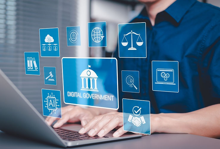 Person typing on laptop with blue holograms displaying icons and "Digital Government" text. Focus on technology, modern feel.