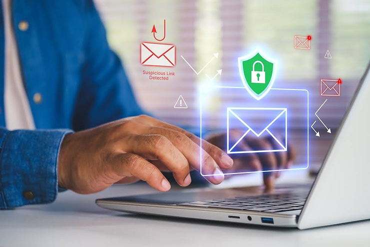 Hands typing on a laptop with holographic email icons. A warning reads "Suspicious Link Detected," highlighting cybersecurity.