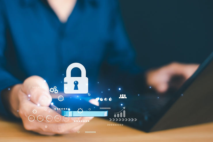 A person in blue uses a smartphone with a lock icon floating above, symbolizing security. A laptop is in the blurred background.