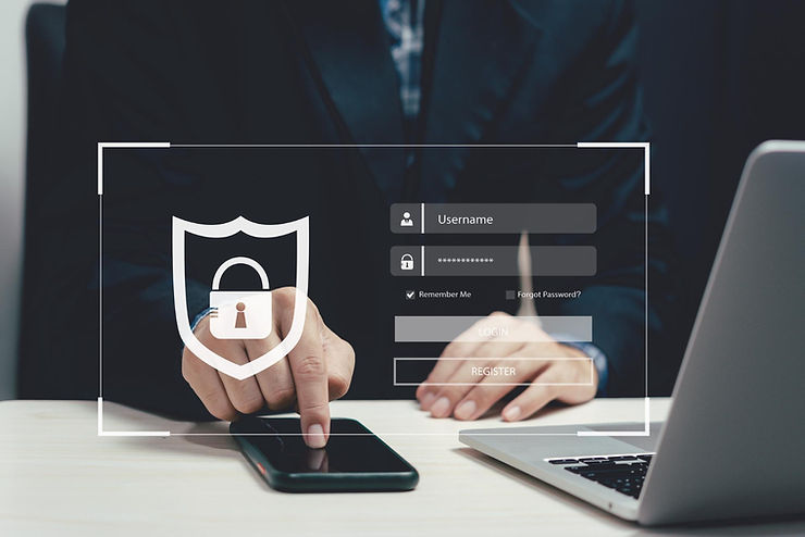 Person in a suit uses a smartphone next to a laptop; overlaid login interface with shield icon. Moody, tech-savvy setting.