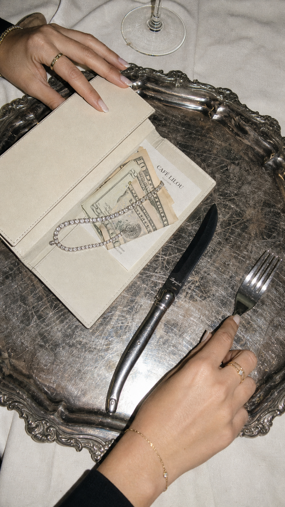 A martini resting on folded cash.