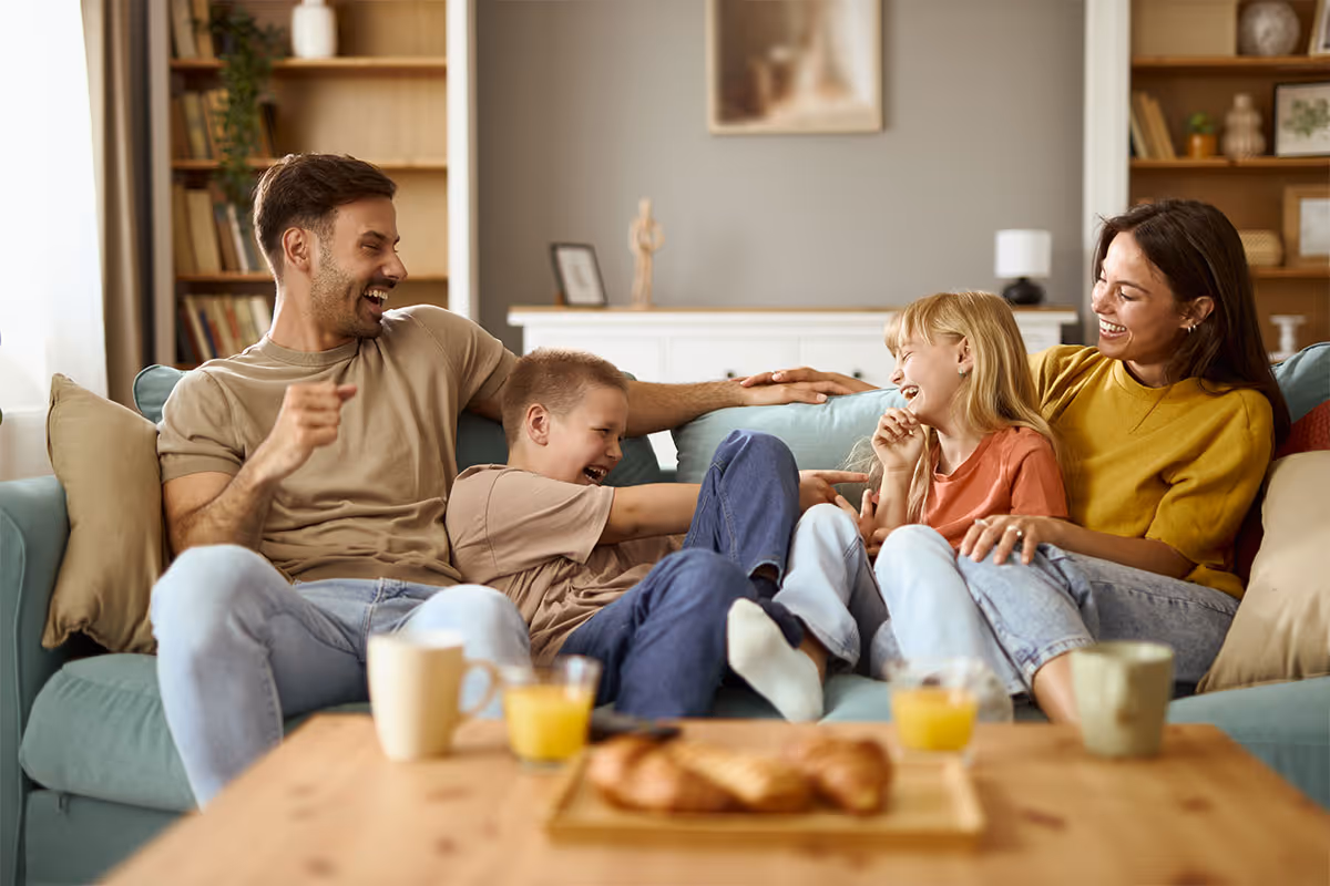 A happy family on the sofa.