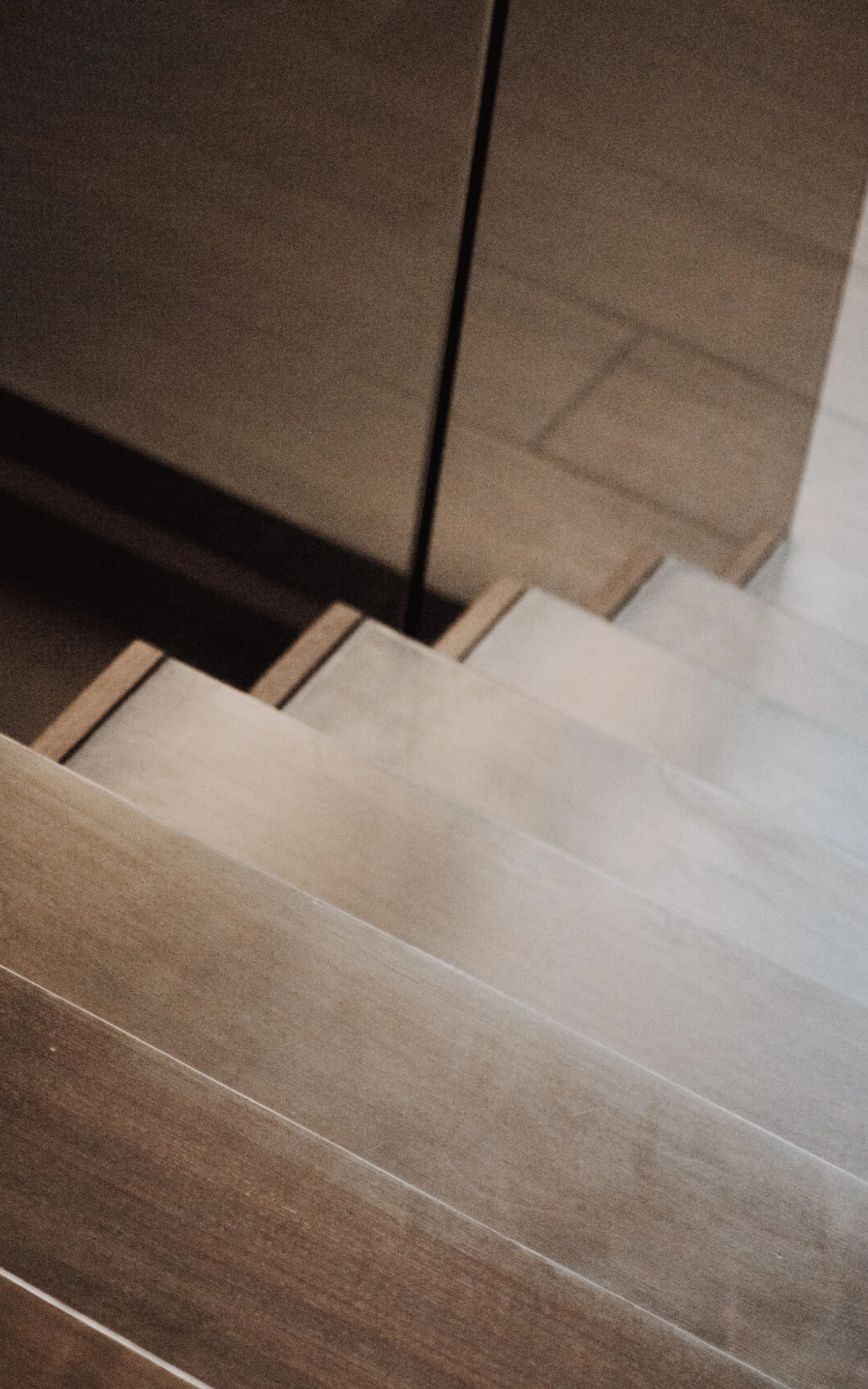Top view of FLIGHT Cantilever stairs with light-bronze-tinted Vedera glass railing.