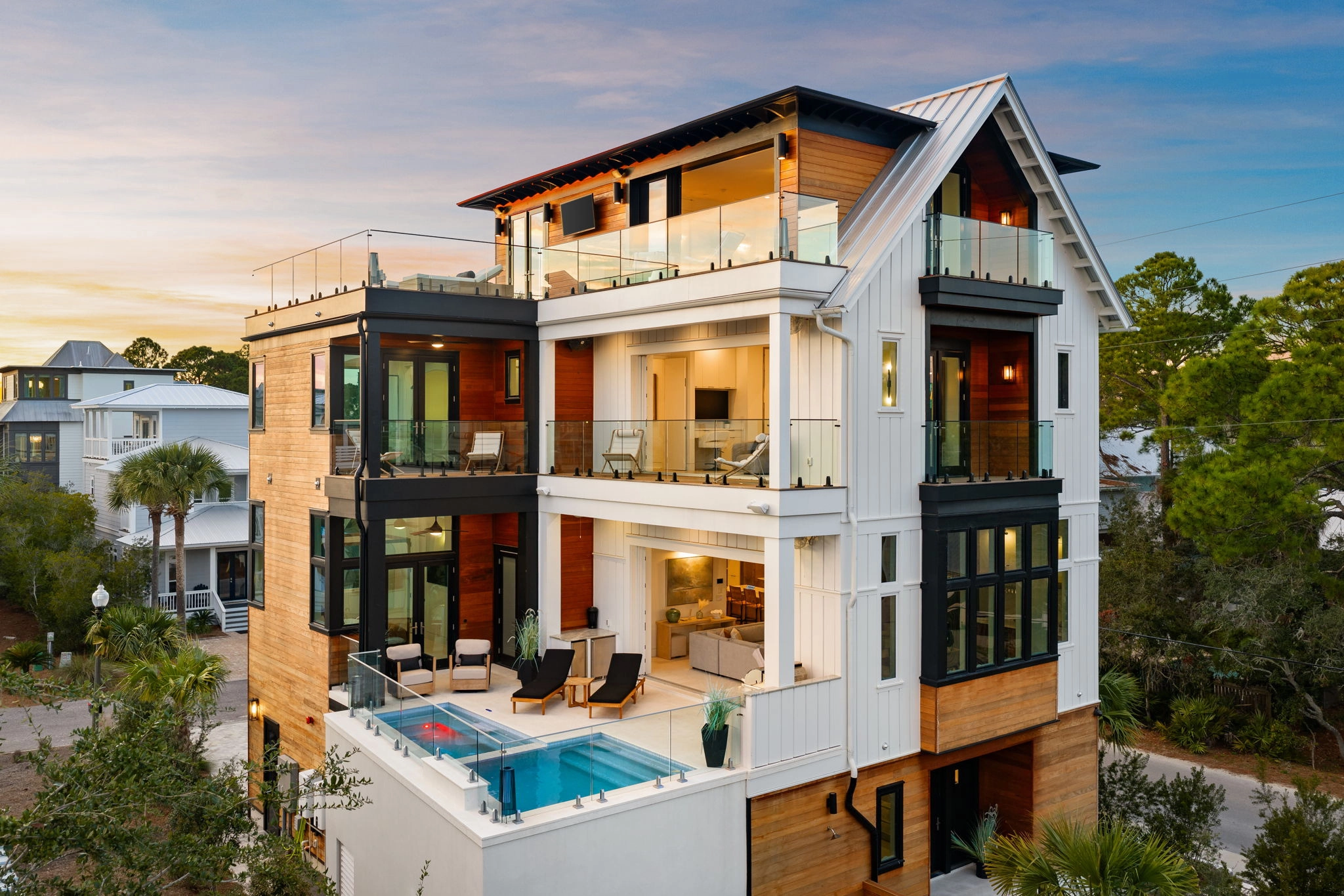 The same coastal home at sunset, its balcony glass standing on Talon Spigots