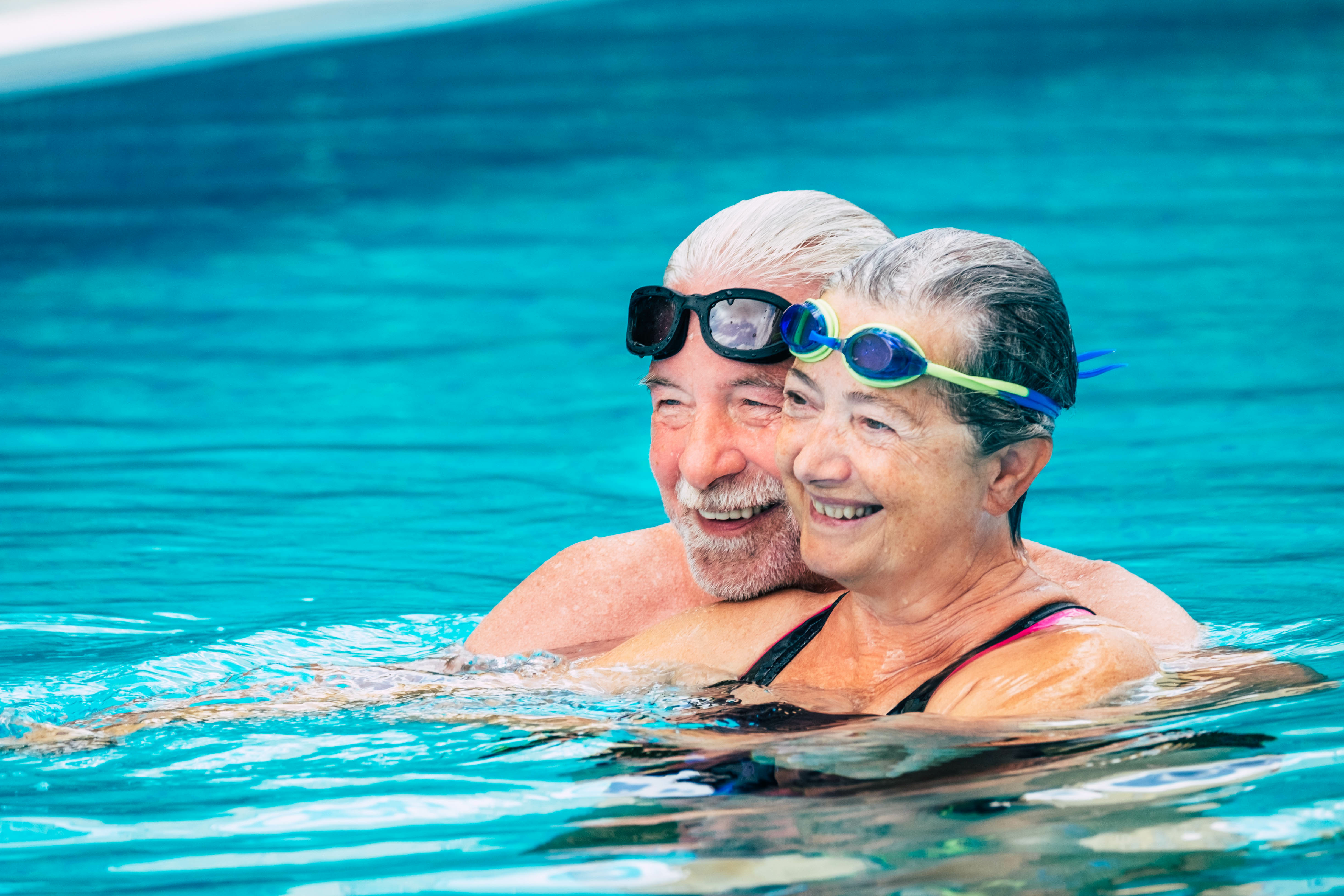 Senior man and woman in the pool stock image