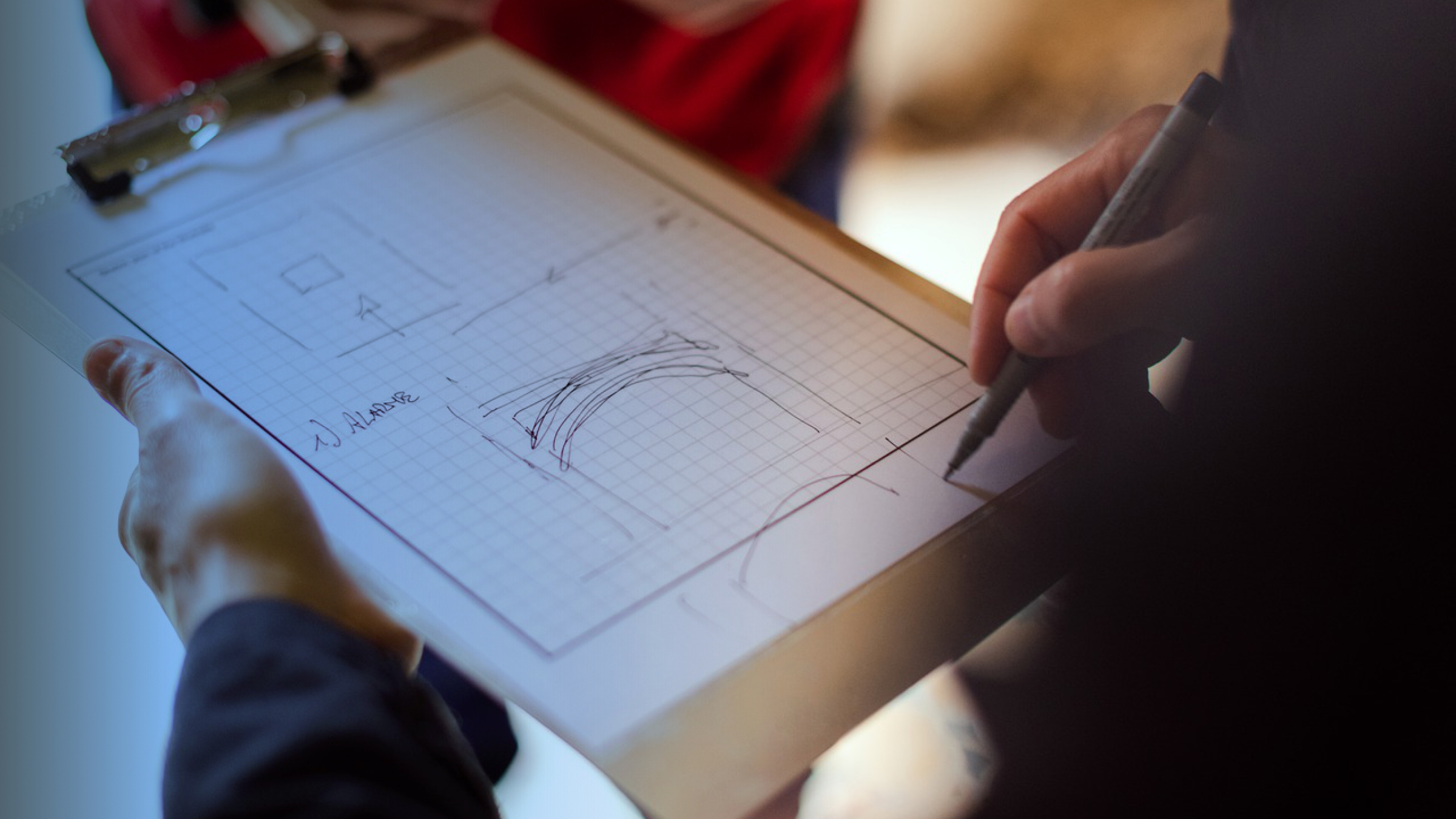 Contractor sketching a painting estimate on a clipboard