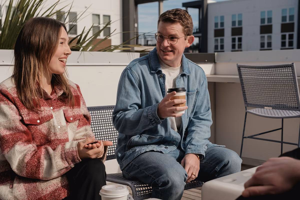 A woman and man talking to each other outside.
