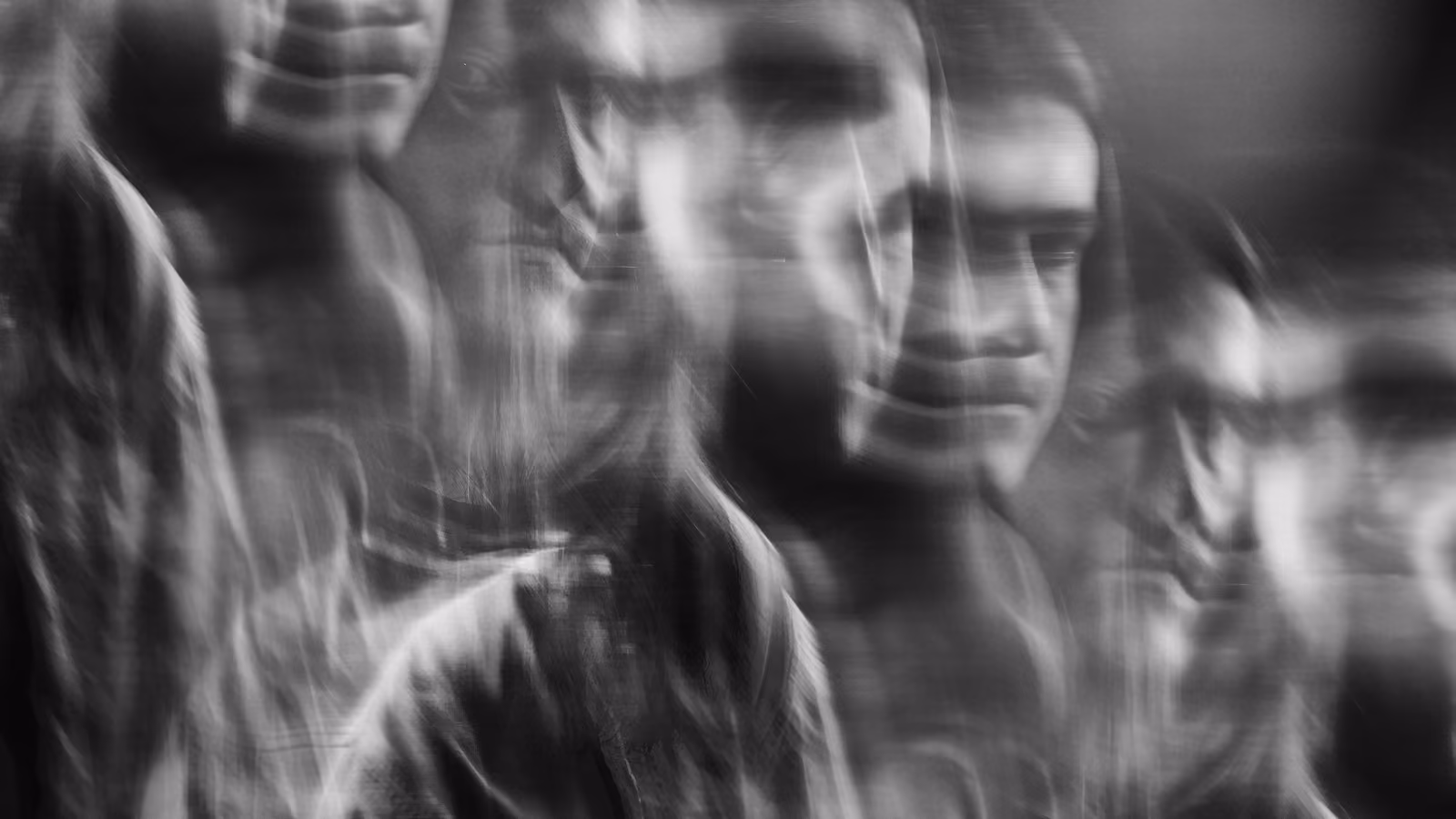 A blurred abstract image of a person in black and white.