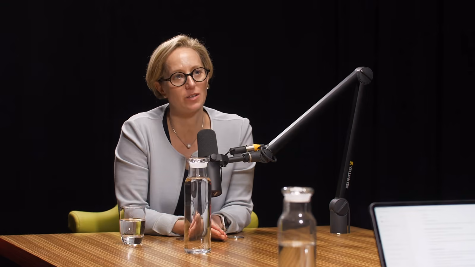 A woman talking on a podcast.