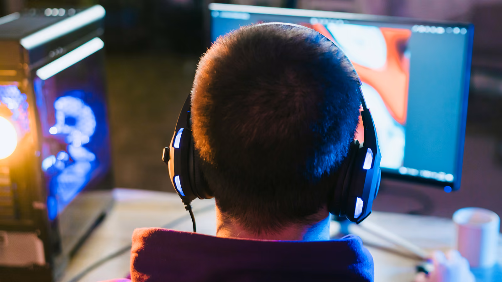 A young adult gaming on a computer.