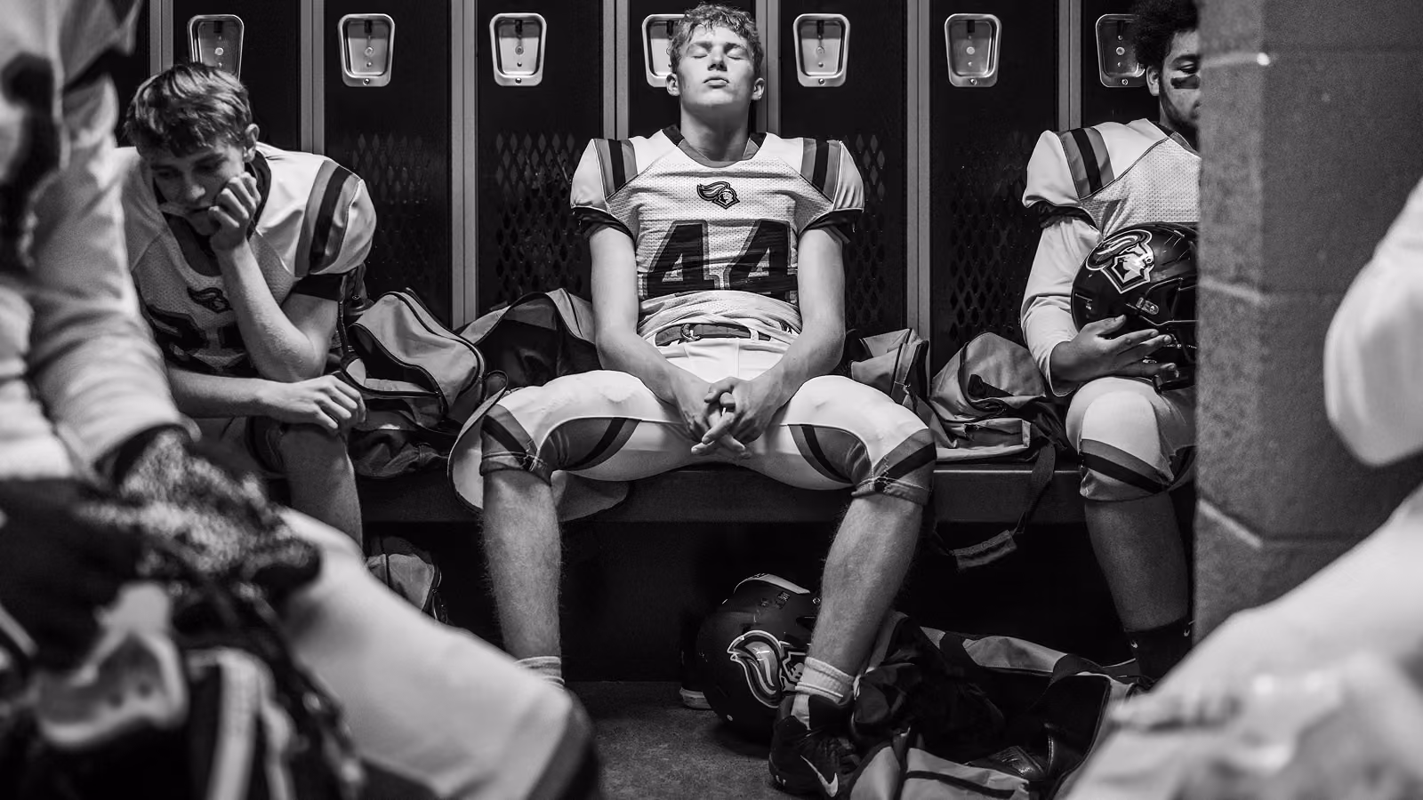 Football player in locker room.