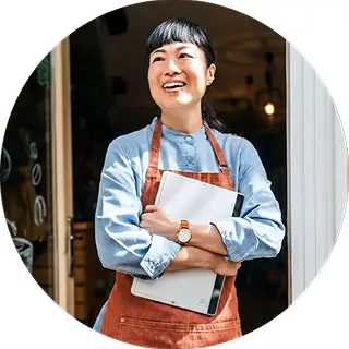 A woman standing holding a restaurant menu