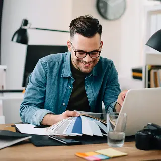 A man sitting down on a laptop