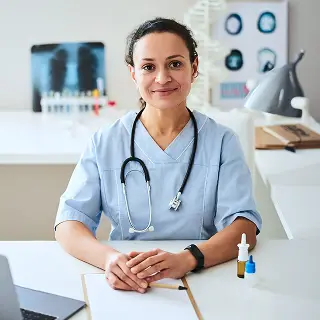 A woman nurse sitting and smiling