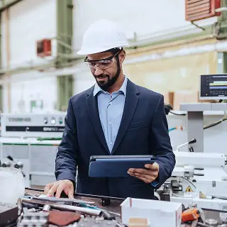 A man standing with a white hard hat