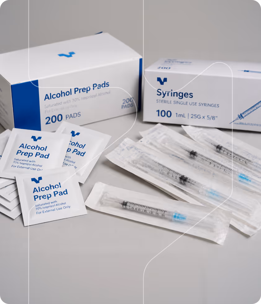 Boxes of alcohol prep pads and sterile syringes with individually wrapped syringes and alcohol pads.