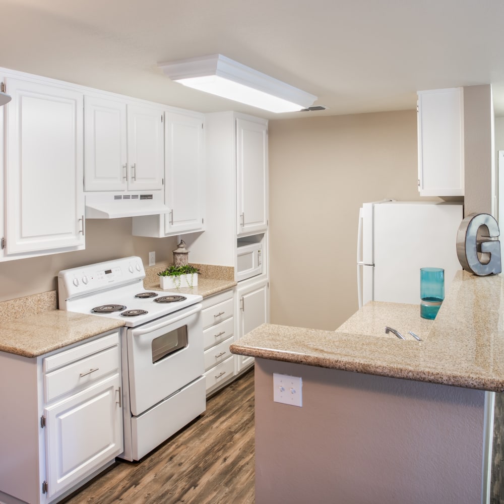 Kitchen with white cabinets and white appliances