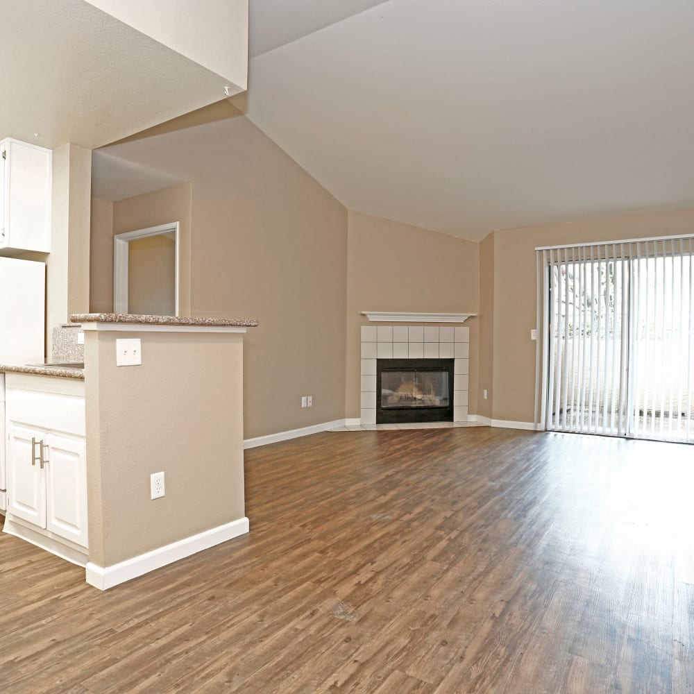 Unfurnished living area with fireplace and wood floors